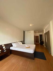 邦劳Ananyana Leisure Beach Resort的卧室配有一张白色的大床,铺有木地板