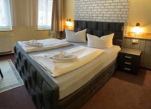 莱比锡克劳塞维茨卡尔酒店的一间卧室配有两张带毛巾的床