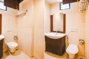 兰奇FabHotel Emerald的一间带水槽、卫生间和镜子的浴室