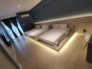哥打巴鲁HOTEL SENTOSA KOTA BHARU Kelantan的一间大卧室,内设两张带灯的床铺