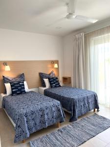 圣保罗湾城Villa Michael的一间卧室设有两张床和窗户。