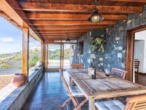 洛斯·亚诺斯·德·阿里丹Casa Pedrito - Cozy House, dreamy Terrace & Sea views的一间带木桌和椅子的用餐室