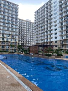 Lapu Lapu CitySaekyung Condominium的两个大建筑前的大型游泳池