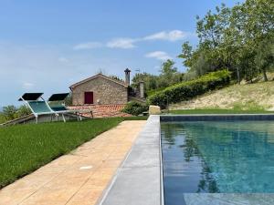 阿尔库阿佩特拉尔卡Villa degli ulivi by Holiday World的石头房子前面的游泳池