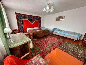 OrgochorKayyr Guest House的一间设有两张床的房间和一张地毯