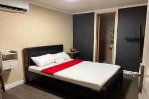 马尼拉Remedios Hotel的一间卧室配有一张带红色毯子的大床