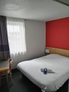 蒙吕松Hotel Inn Design Montluçon的一间卧室配有一张蓝色的床