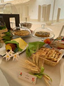 西尼加利亚Naturaverde Country House的一张桌子上放着馅饼和其他食物