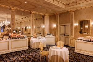 科莫Palace Hotel Lake Como的一间设有两张桌子和自助餐的用餐室