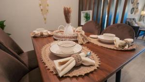 欧普尔منتجع قوفالي的一张木桌,上面有盘子和盘子