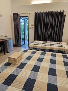 潘切Catsen Bungalows & Pool Phan Thiet的一间卧室设有两张床和滑动玻璃门