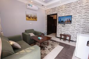 An NimāşTaraf Al Asalah Villas的带沙发和砖墙的客厅