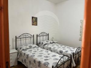 切萨雷奥港Villetta Zora - Spiaggia a 250m的卧室内两张并排的床