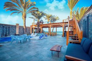 达哈布NEOM DAHAB - - - - - - - - - - - Your new hotel in Dahab with private beach的棕榈树和楼梯的度假庭院
