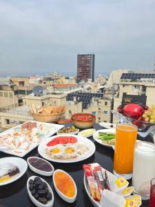 贝鲁特皇后套房酒店的城市顶端带食物和饮料的桌子