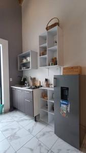 奥里萨巴Departamento Loft B的厨房配有不锈钢冰箱和架子