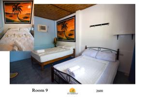 圣维森特Ocean Mist Tourist Inn的一间设有两张床的客房,并拥有棕榈树的照片