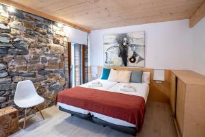 吉塔里亚Aristondo Pentsioa的一间卧室设有一张床和石墙