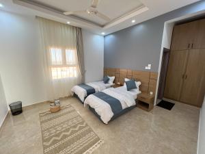 Al RakaR61 Sunrise Chalet的一间卧室设有两张床和大窗户