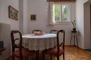 雅典ΔΙΠΛΑ ΣΕ ΜΕΤΡΟ , ΚΟΝΤΑ ΣΤΗΝ ΑΚΡΟΠΟΛΗ的餐桌、椅子和窗户