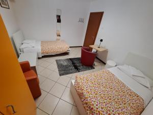 卡拉尔佐Lunga Via Delle Dolomiti的客房设有两张床、一张桌子和镜子