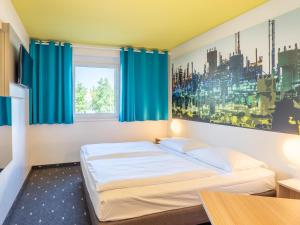 莱茵河畔路德维希港路德维希港B&B酒店的一间卧室配有蓝色窗帘的床