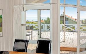 海耶斯Stunning Home In Sjlund With House Sea View的一间用餐室,配有滑动玻璃门,可通往甲板
