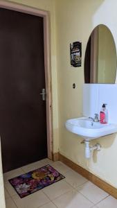 莫罗戈罗Kinyanjui's Homes 001 with WiFi的浴室设有白色水槽和镜子