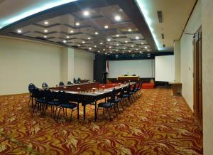 沙马林达Five Premiere Hotel的大型会议室,配有长桌子和椅子