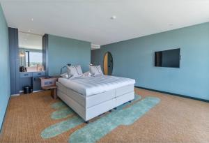霍夫多普史基浦A4凡德瓦克酒店的一间蓝色卧室,配有一张床和电视