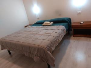 特雷维索Carpe Diem的一间小卧室,配有床和床头柜