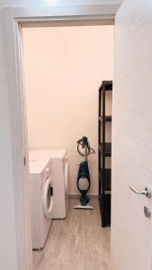 阿尔盖罗Thomas' House的浴室位于卫生间旁,配有洗衣机。
