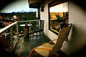 墨西哥城阿兹蒂行政套房酒店的阳台配有桌椅和窗户。