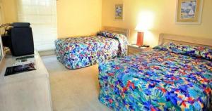 帕瓦雷斯岛利奇菲尔德海滩高尔夫度假酒店的一间卧室配有两张床和电视。