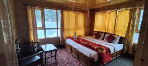 帕哈尔加姆New Snow View Resort pahalgam的一间设有床铺的卧室,位于带窗户的房间内