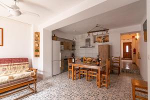 VillamaleaCasa Rural El Olivo的厨房以及带桌椅的起居室。