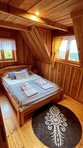 新塔尔格Domek w Górach- Bacówka u Dudka的小木屋内一间卧室,配有一张床
