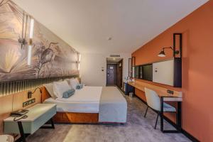 安塔利亚客安贝斯特韦斯特酒店的酒店客房设有一张大床和一张书桌。