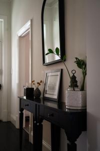 塔南达巴罗莎住宿加早餐旅馆的一张黑色桌子,上面有镜子和植物