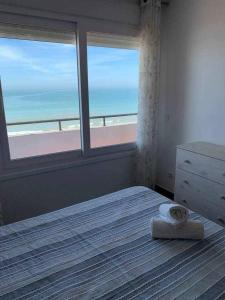 加的斯El Mirador de la Playa Cortadura Grupo AC Gestion的一间卧室配有一张床,享有海滩美景
