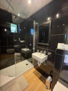 普孔French Andes Apart Hostel的大型浴室设有水槽和淋浴。