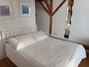 哈斯尔米尔LITTLE OAK - Kingsize Double Oak Studio - Sleeps 2 - Quirky - Rural的卧室内的一张白色床,设有窗户