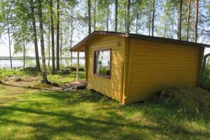 HiidenniemiMarjoniemi Camping的树林中草木上的小屋