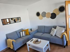 奇克拉纳－德拉弗龙特拉Villa "El Salao"的客厅配有蓝色的沙发和桌子