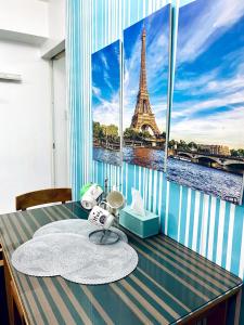 马尼拉Azure staycation by C&N的带桌子的客房享有艾菲尔铁塔的景致。
