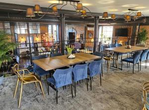 沃姆扎潘思捷耐特复古酒店的一间设有两张桌子和蓝椅的用餐室