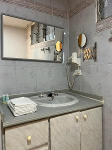 亚美尼亚Hotel Armenia Centro的一间带水槽和镜子的浴室