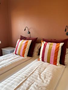 Nesjum塞特贝格旅馆的一张床上有两个枕头的房间