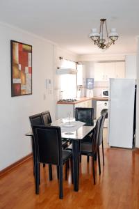 安托法加斯塔阿莫布拉多斯拉赫尔曼达迪公寓的厨房里配有餐桌和椅子