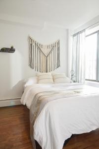 纽约American Dream Guest House的白色卧室设有一张大床和窗户